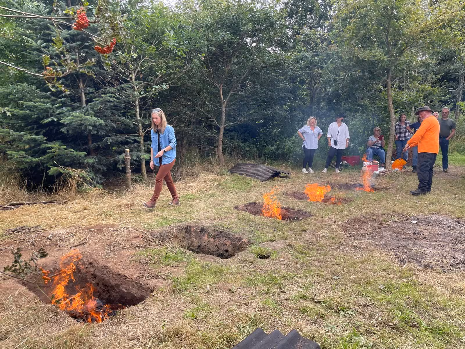 Picture of people gathered around burning fire
pits